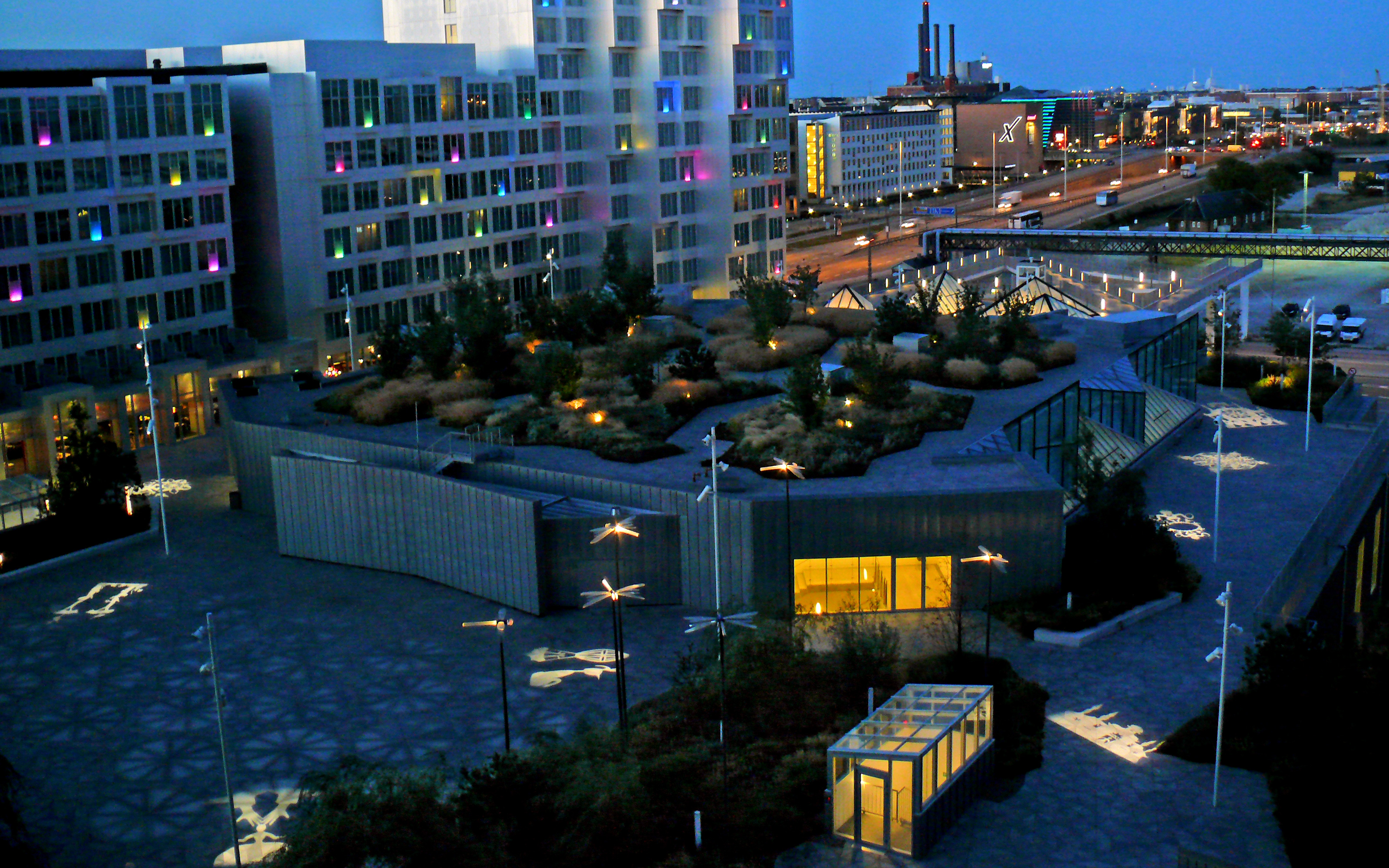 Spotlights project different light objects onto the roof surface at night. Illuminated roof at night